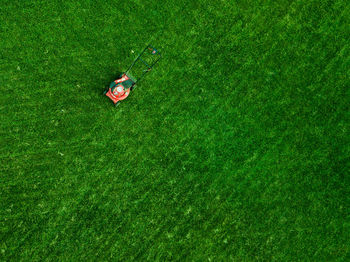 High angle view of lawn mover on grassy field