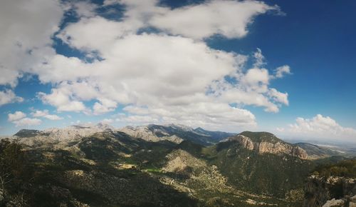 Scenic view of mountains against cloudy sky