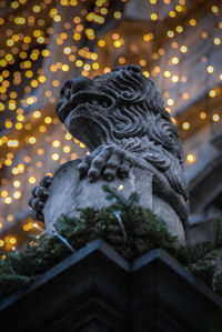 Low angle view of statue against sky at night