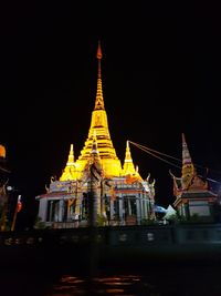 Illuminated building against sky at night