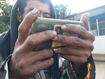 Close-up of man using mobile phone