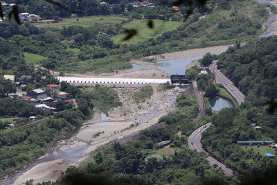 High angle view of road amidst trees and buildings