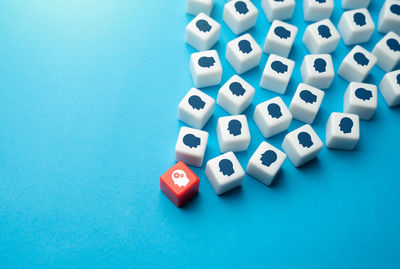 High angle view of dices on blue background