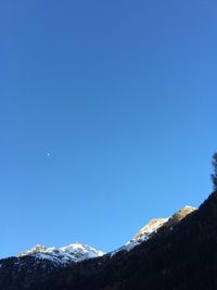 Scenic view of mountains against clear blue sky