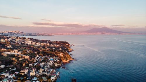 High angle view of townscape by sea against sky