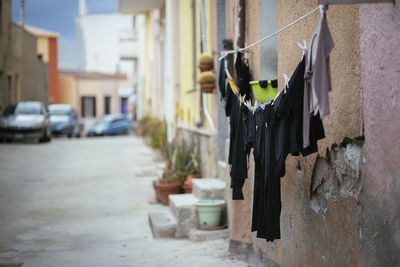 Side view of clothes drying against the wall