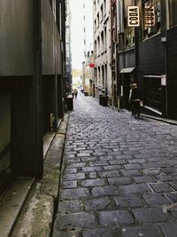 Man walking on cobblestone street