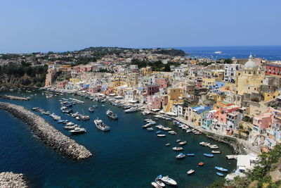 High angle view of town by sea against clear sky