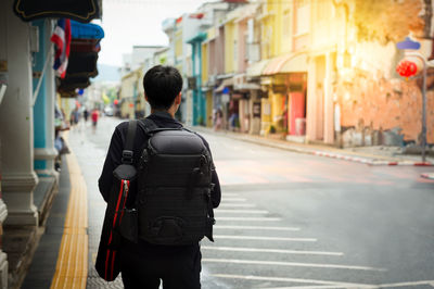 Rear view of man walking on street