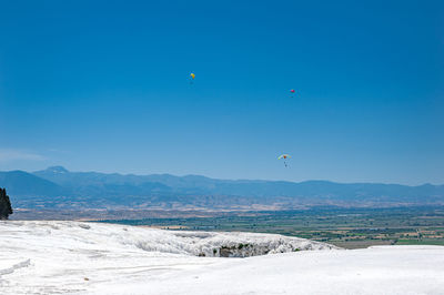 Scenic view of mountains against blue sky