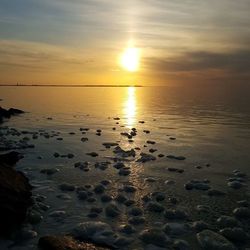 Scenic view of sea against sky at sunset