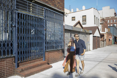 Young couple walking along a street together