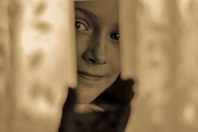 Close-up portrait of cute girl smiling at home