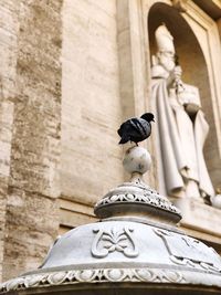 Low angle view of statue against building