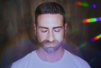 Close-up portrait of young man with eyes closed