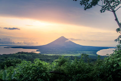 Scenic view of sea and mountains against sky