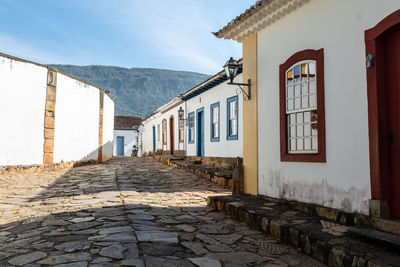 Street amidst buildings in town against sky