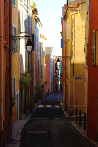 Empty alley amidst buildings in city