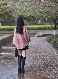 Rear view of woman standing in park