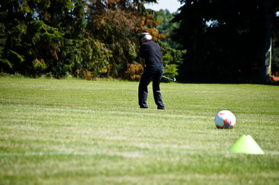 Full length of man playing with ball