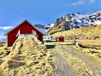 Houses on snow covered landscape against sky