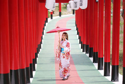 Rear view of woman standing on red steps