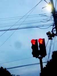 Low angle view of power lines against sky