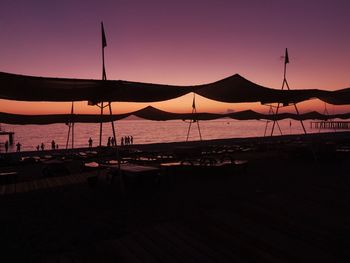 Scenic view of beach against clear sky during sunset