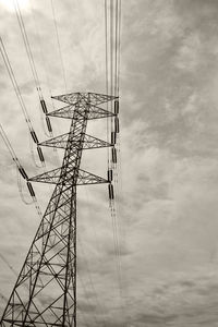 Low angle view of electricity pylon against sky