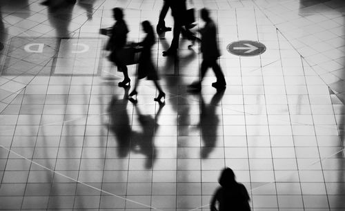 High angle view of people walking on floor