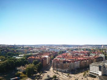 High angle view of townscape against clear blue sky