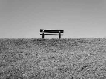 Minimalistic shot of an empty bench on a hill in leyhörn.