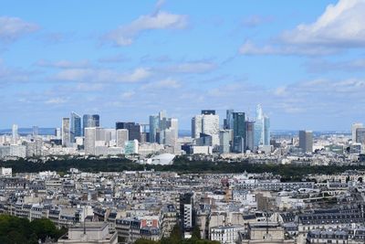 Aerial view of buildings in city against sky