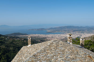 High angle view of townscape by sea against sky