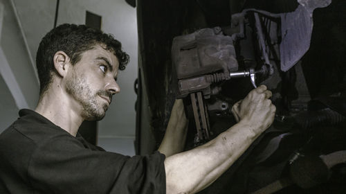 Close-up of man repairing car