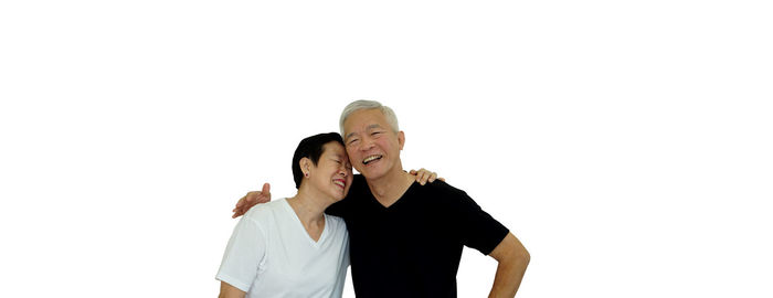 Couple kissing against white background