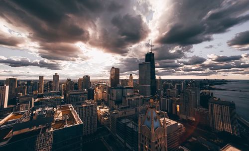 Aerial view of city against cloudy sky