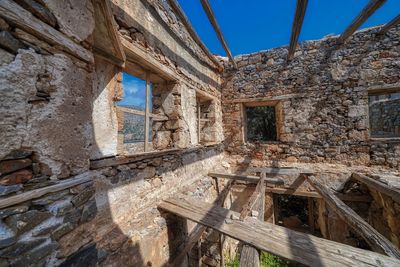 Damaged building against sky