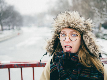 Portrait of woman sticking out tongue