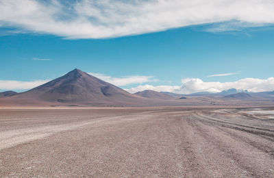 Scenic view of desert against blue sky