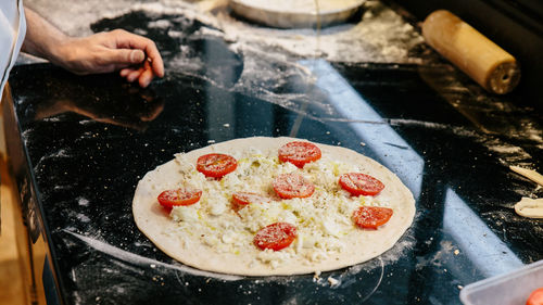 Midsection of person preparing food in kitchen