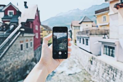 Cropped image of person holding camera