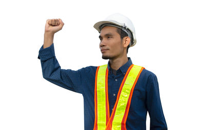 Portrait of man standing against white background