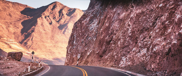 Road leading towards rocky mountains