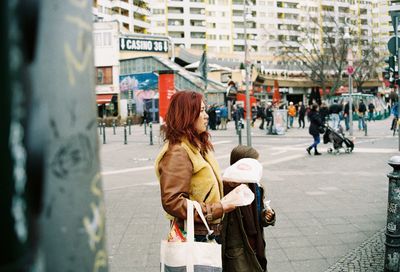 Woman with umbrella in city