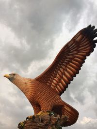 Low angle view of statue against cloudy sky