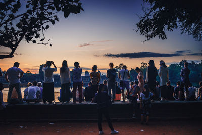 Group of people at beach during sunset