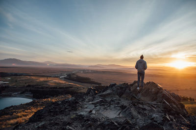 Rear view of man standing on cliff