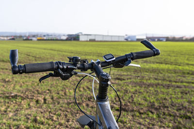 A bicycle handlebar seen from the first person perspective. bicycle frame and bicycle accessories