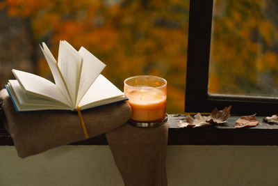 Sweater, candle and autumn decor. autumn home decor.